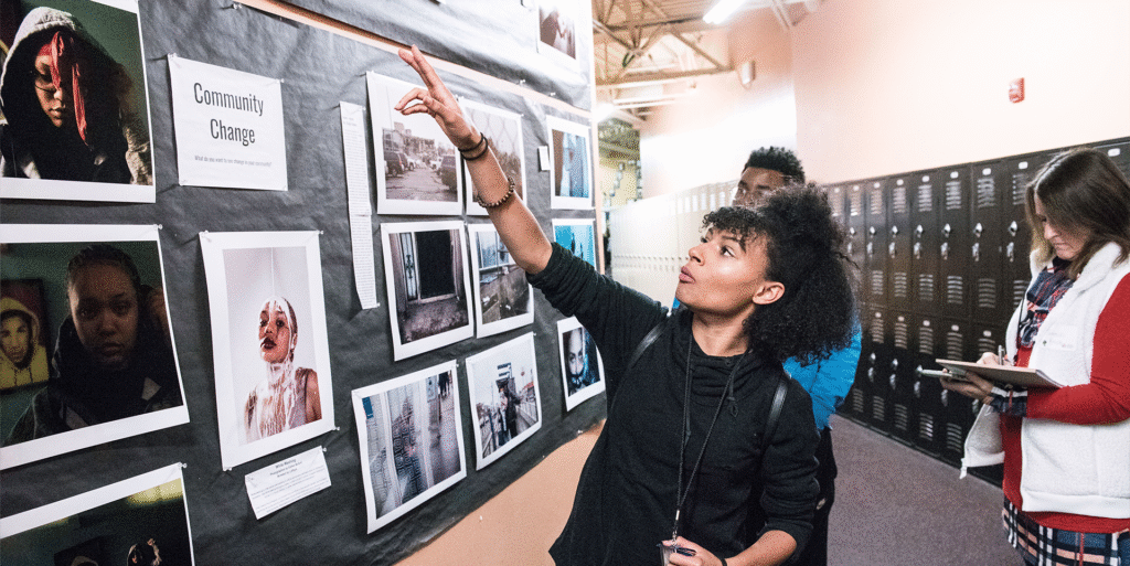 A student tour guide showcasing student work at their school.
