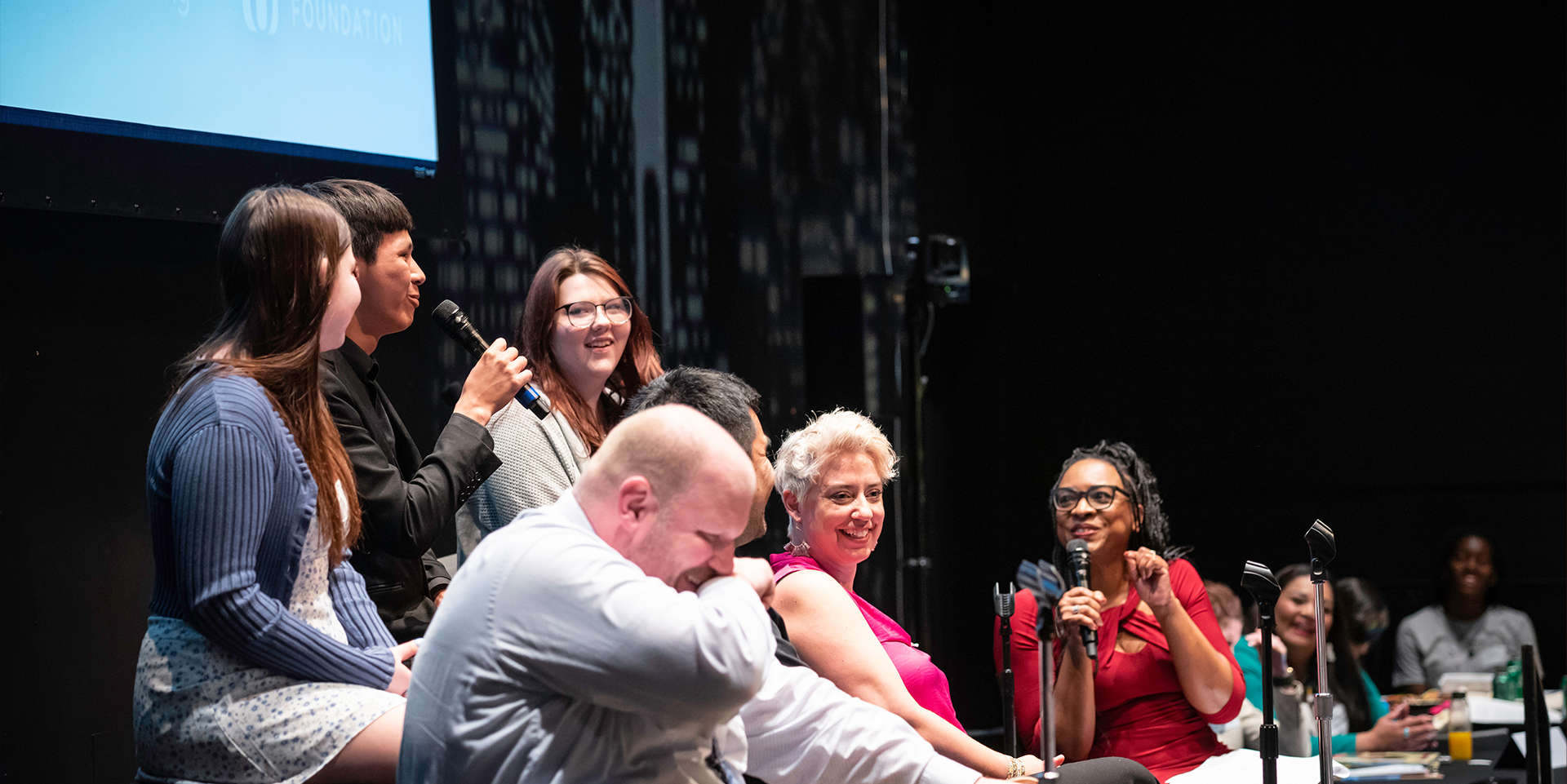 A student speaks on a radio panel at an education event.