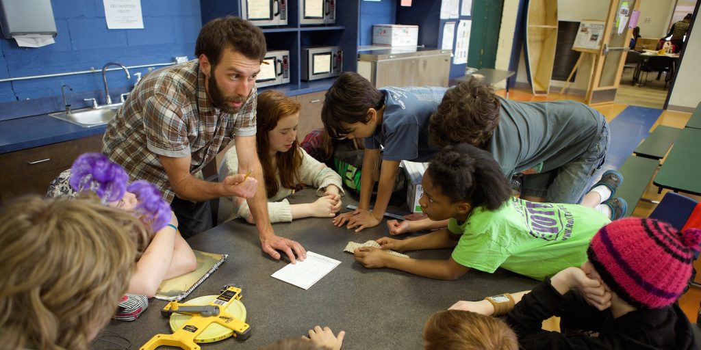 Teacher and students collaborating